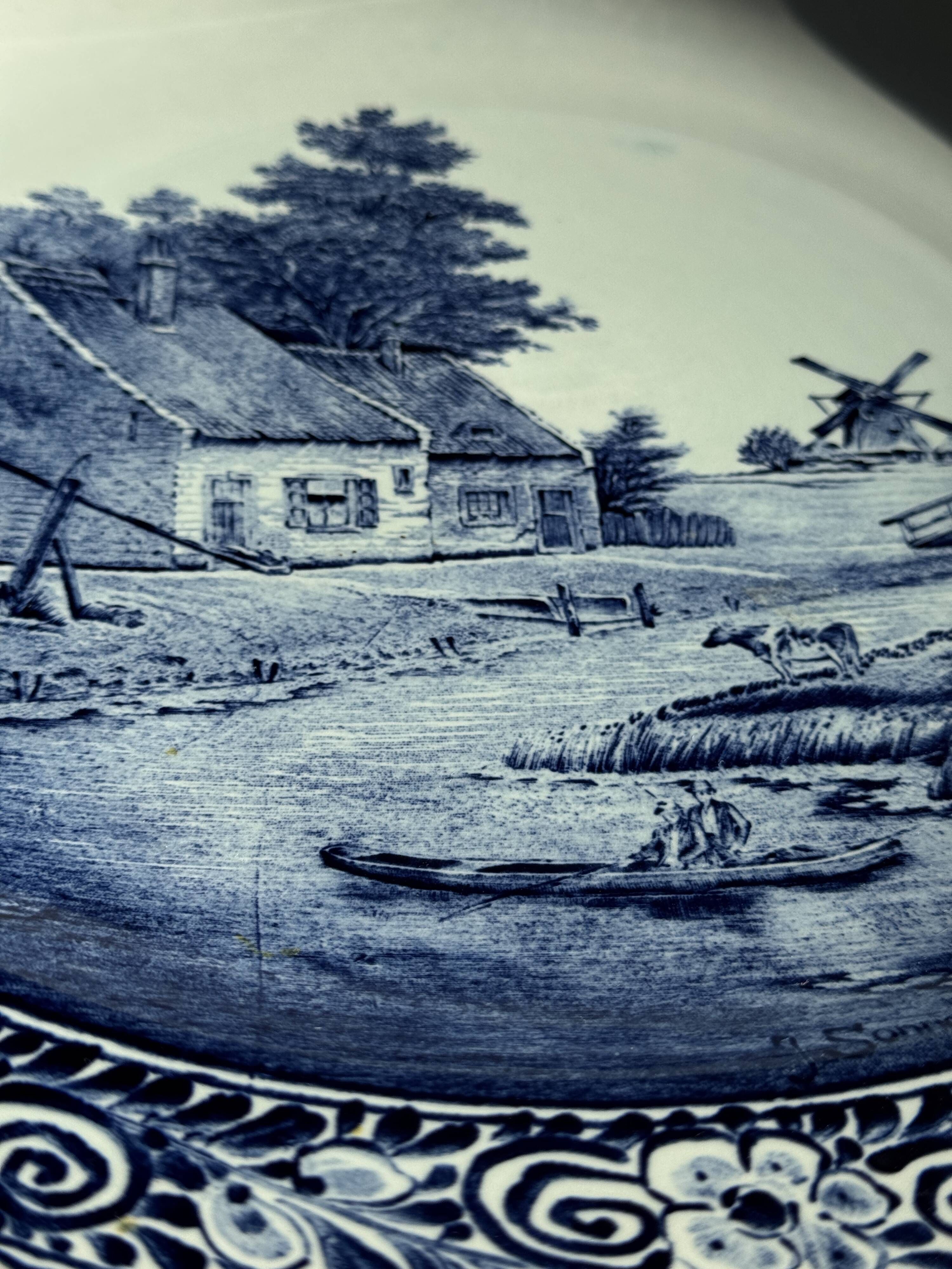 Vintage hollow circular plate in blue and white Boch pottery.