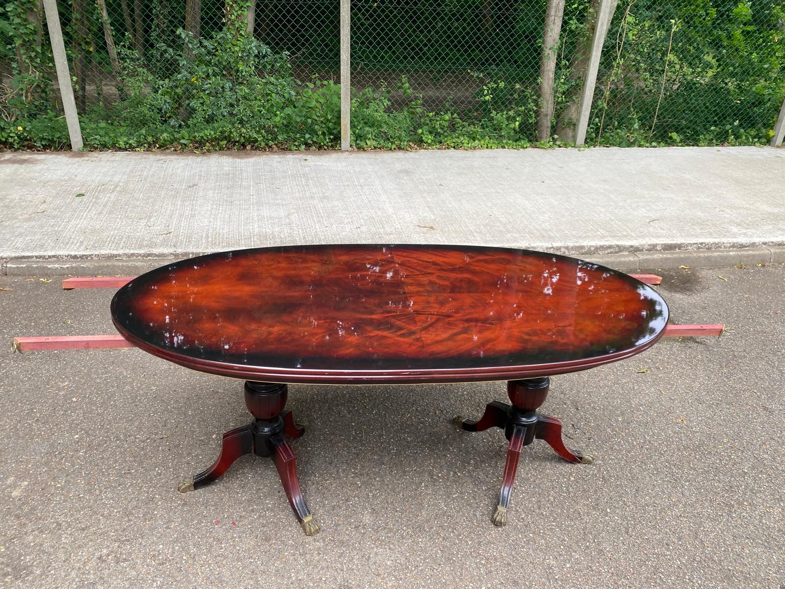 Glossy mahogany dining table in English Regency style from the 1970s.