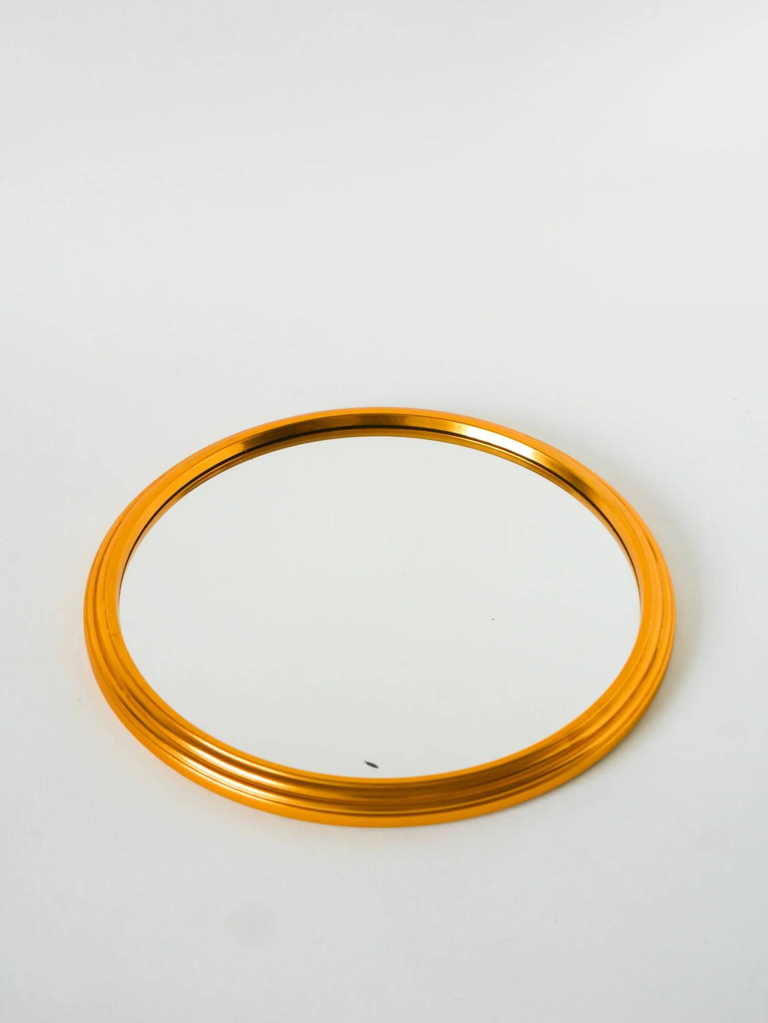 Small round mirror tray, gold, 1960