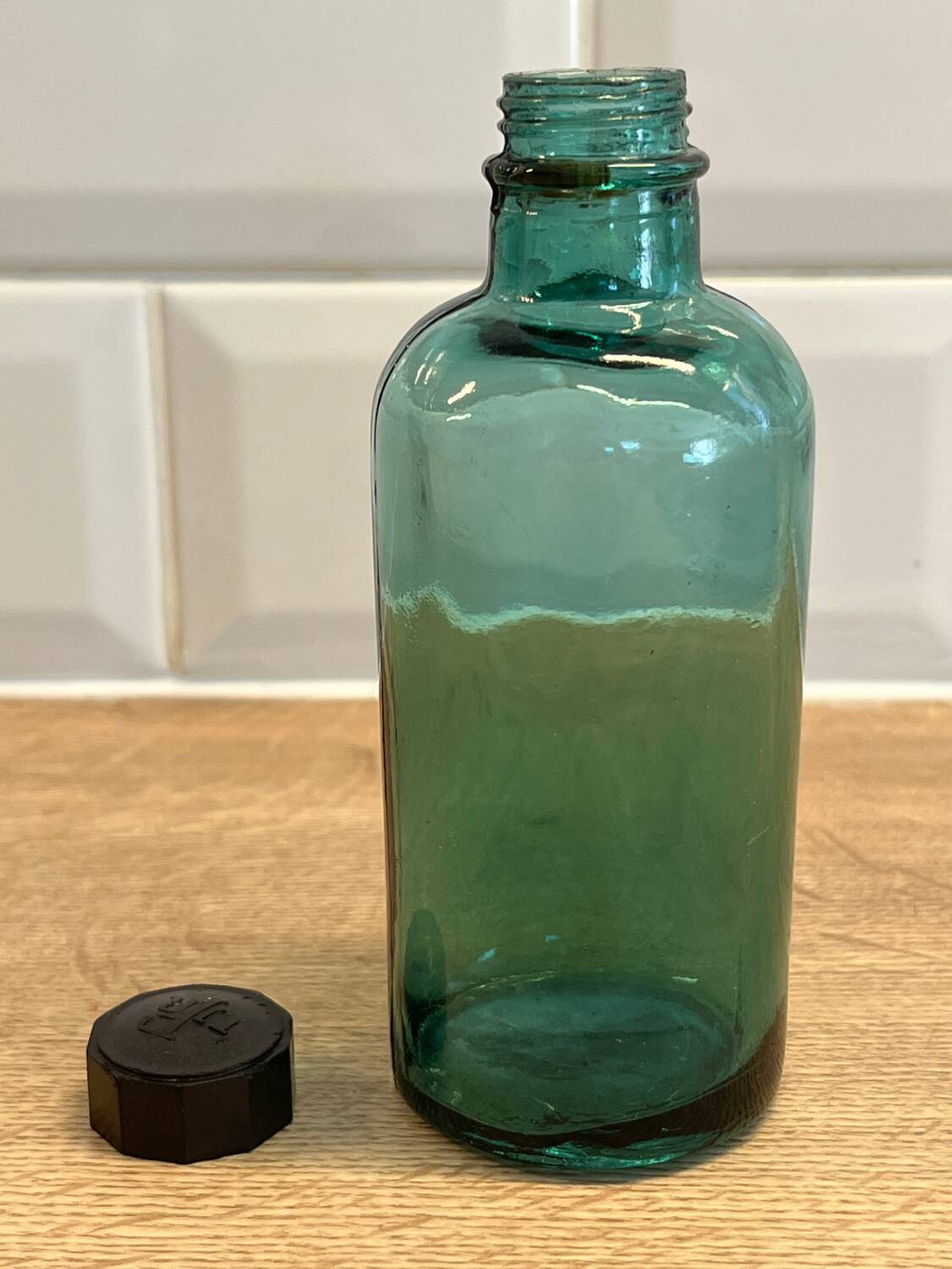 Small vintage dark turquoise blue bottle