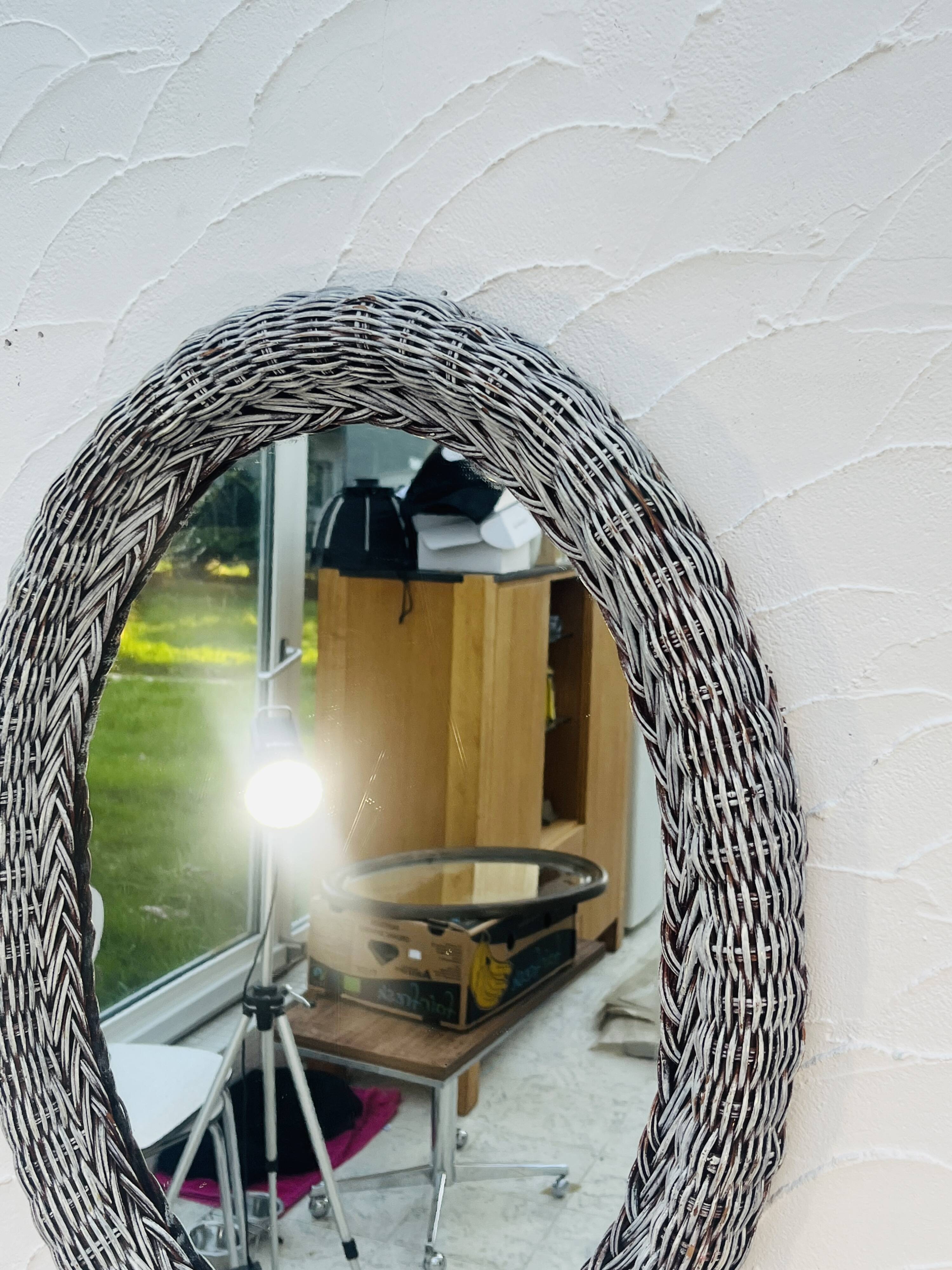 Vintage oval wicker mirror from the 1960s.
