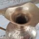 Chiseled brass pitcher decorated foliage