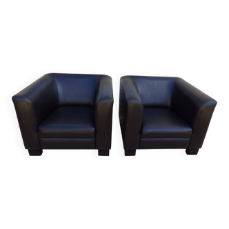 2 club armchairs with a chocolate faux leather seat and backrest and wooden legs.