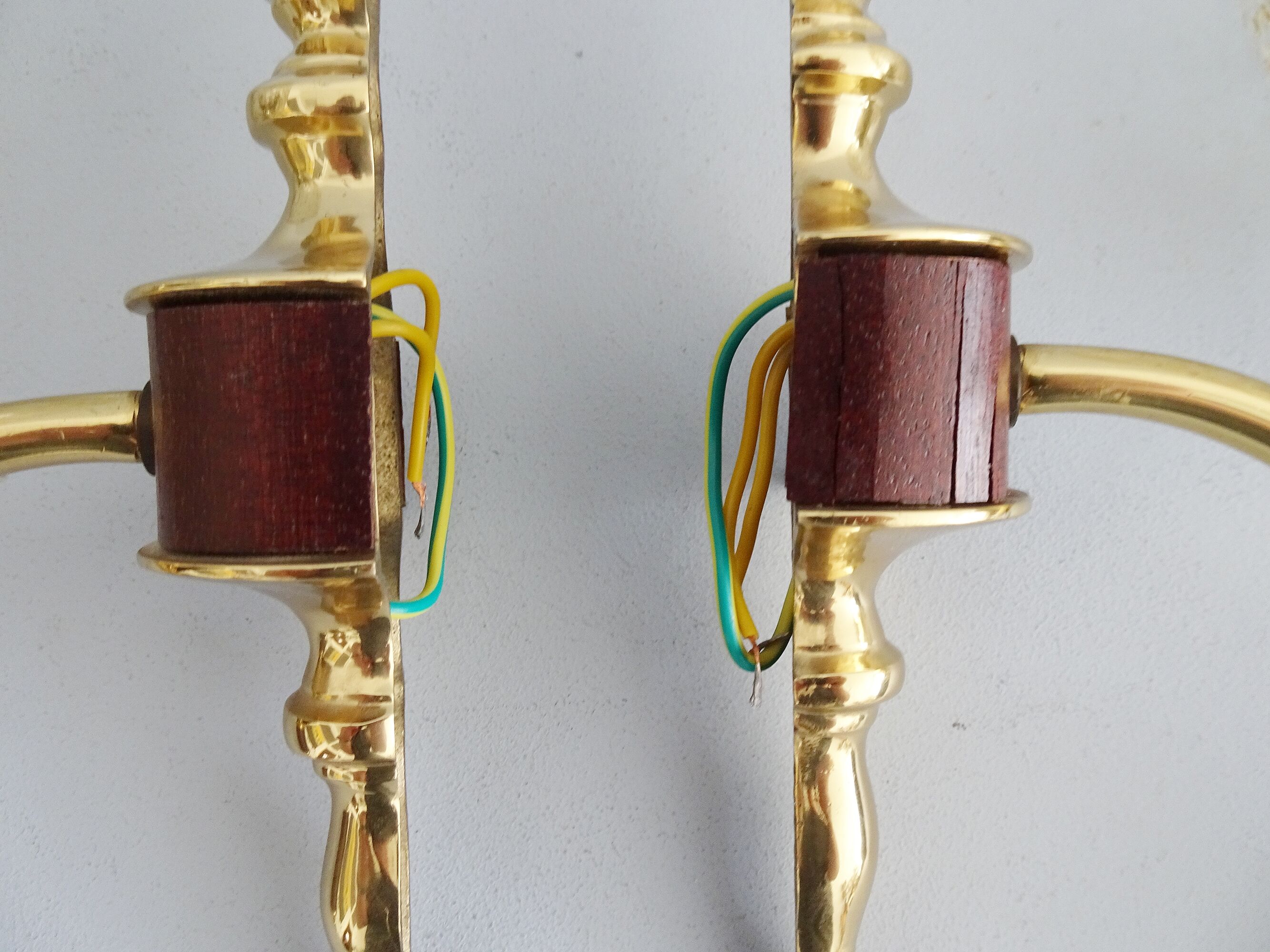 Golden wall lamps with round glass shades and teak veneer