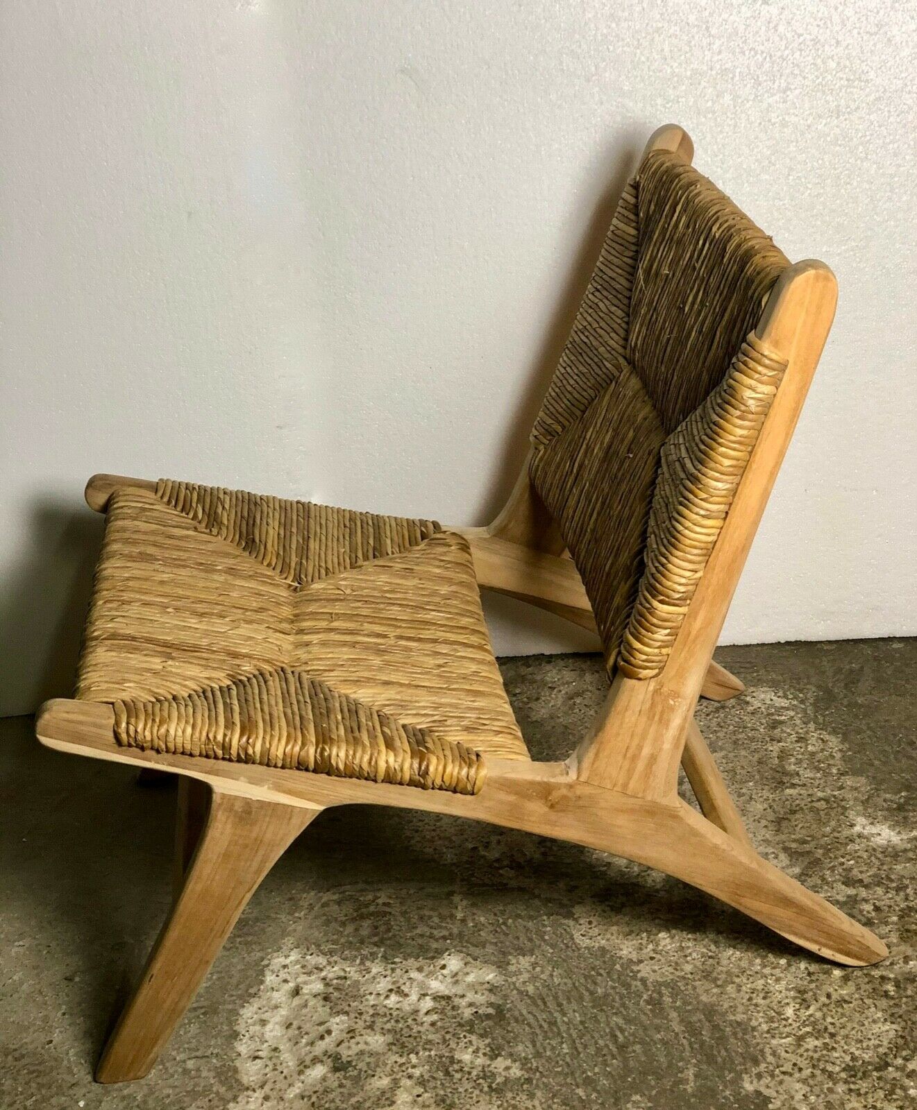 Low armchair in raw teak with seat and mulched backrest