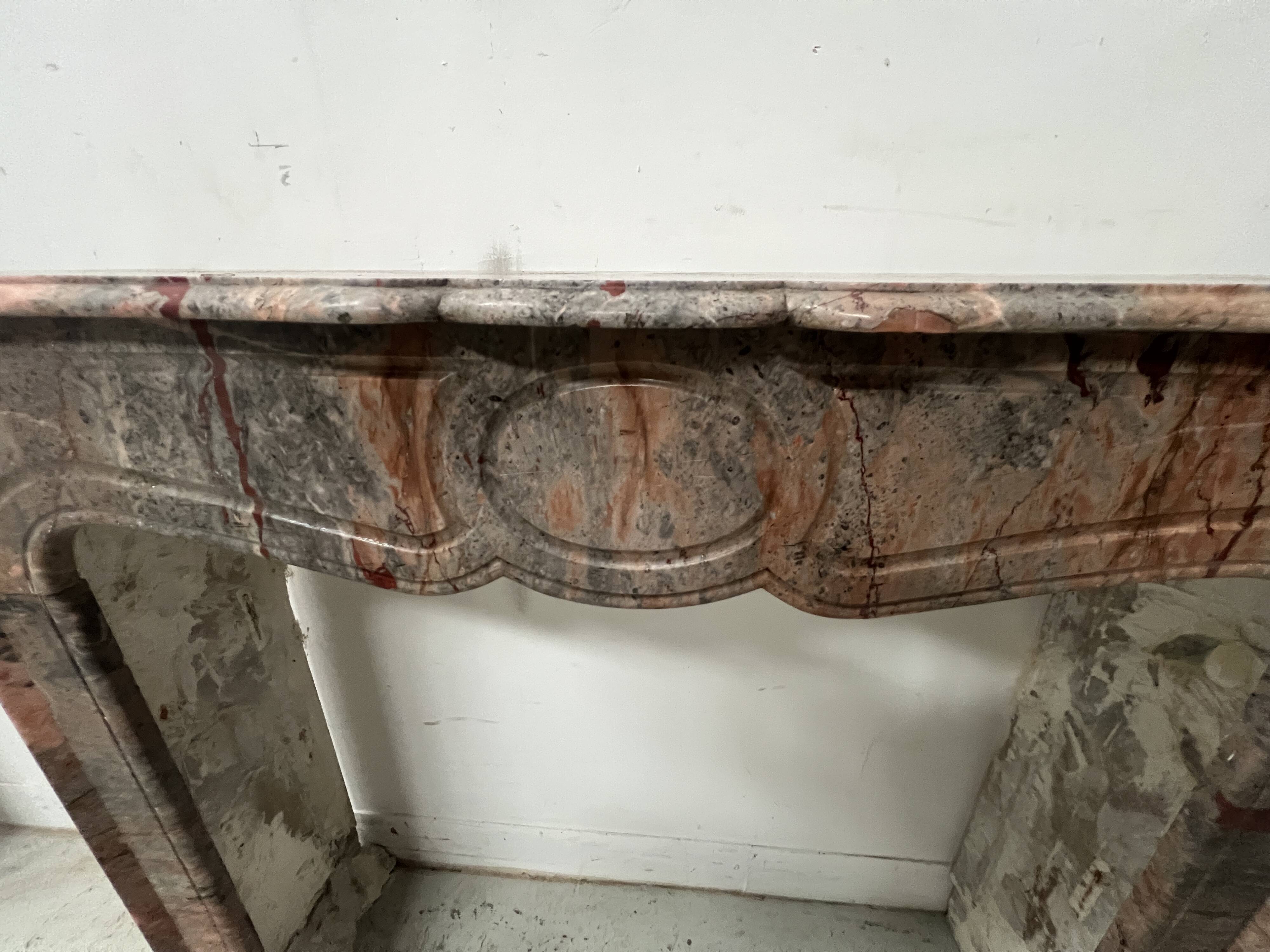 Louis XV style fireplace, "Pompadour" model, grey-pink marble, 20th century