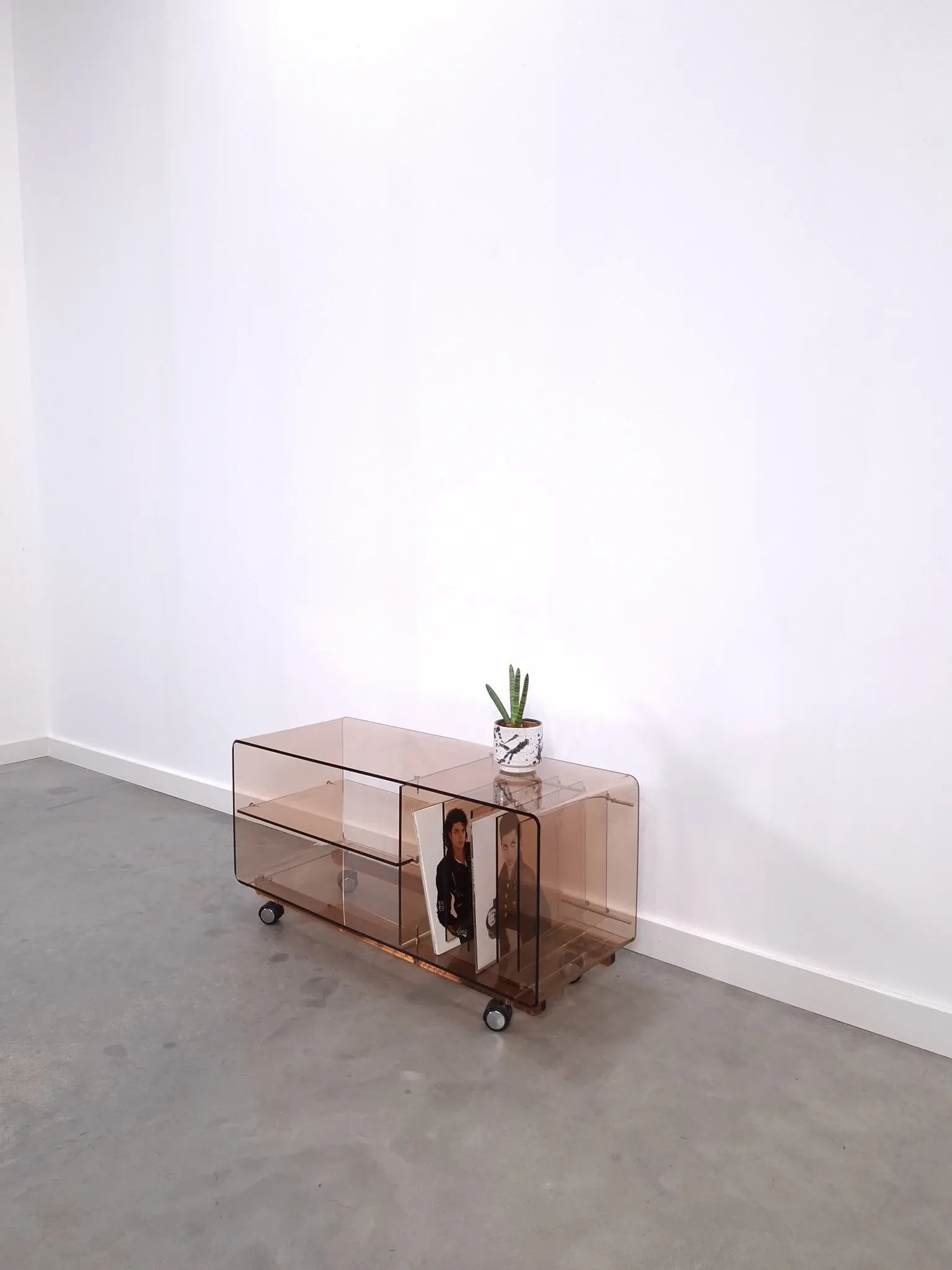 Vintage hifi, LP cabinet, TV unit made of tinted plexiglass on wheels, records.