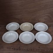 6 old cream-coloured deep plates with blue/orange trim.