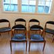 Set of 6 vintage Kai Kristiansen chairs in solid teak and black faux leather.