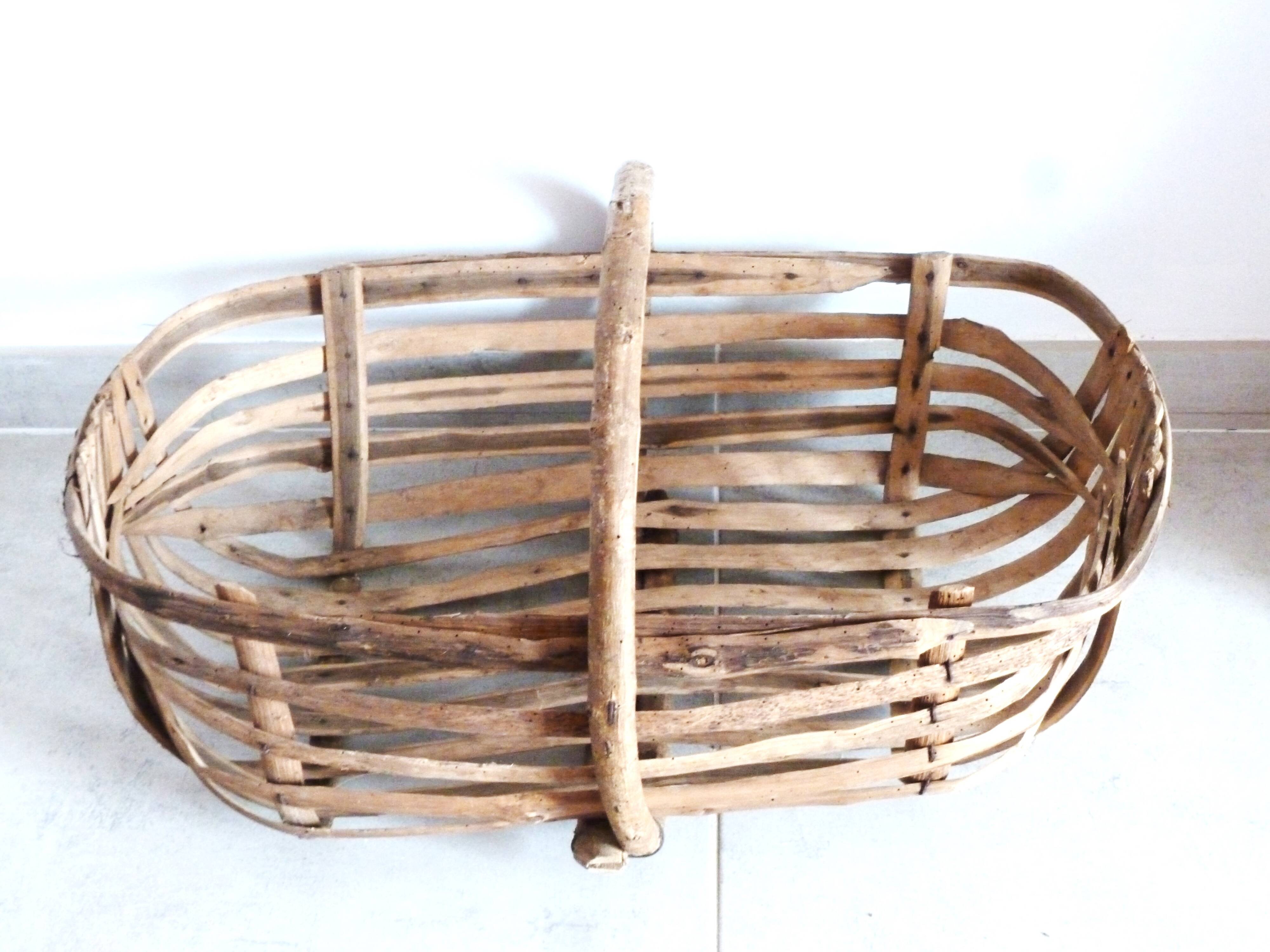 Old wooden harvest basket, slatted wooden basket, folk art.