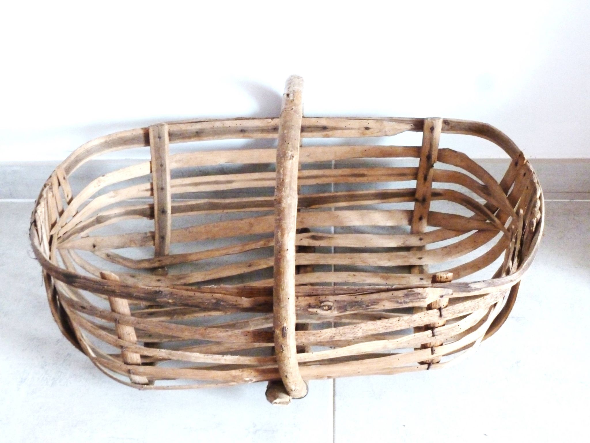 Old wooden harvest basket, slatted wooden basket, folk art.