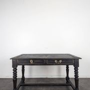 Louis XIII style desk in blackened wood with turned legs and two drawers.