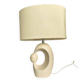 Cream ceramic table lamp with a mid-century design, featuring a lampshade.