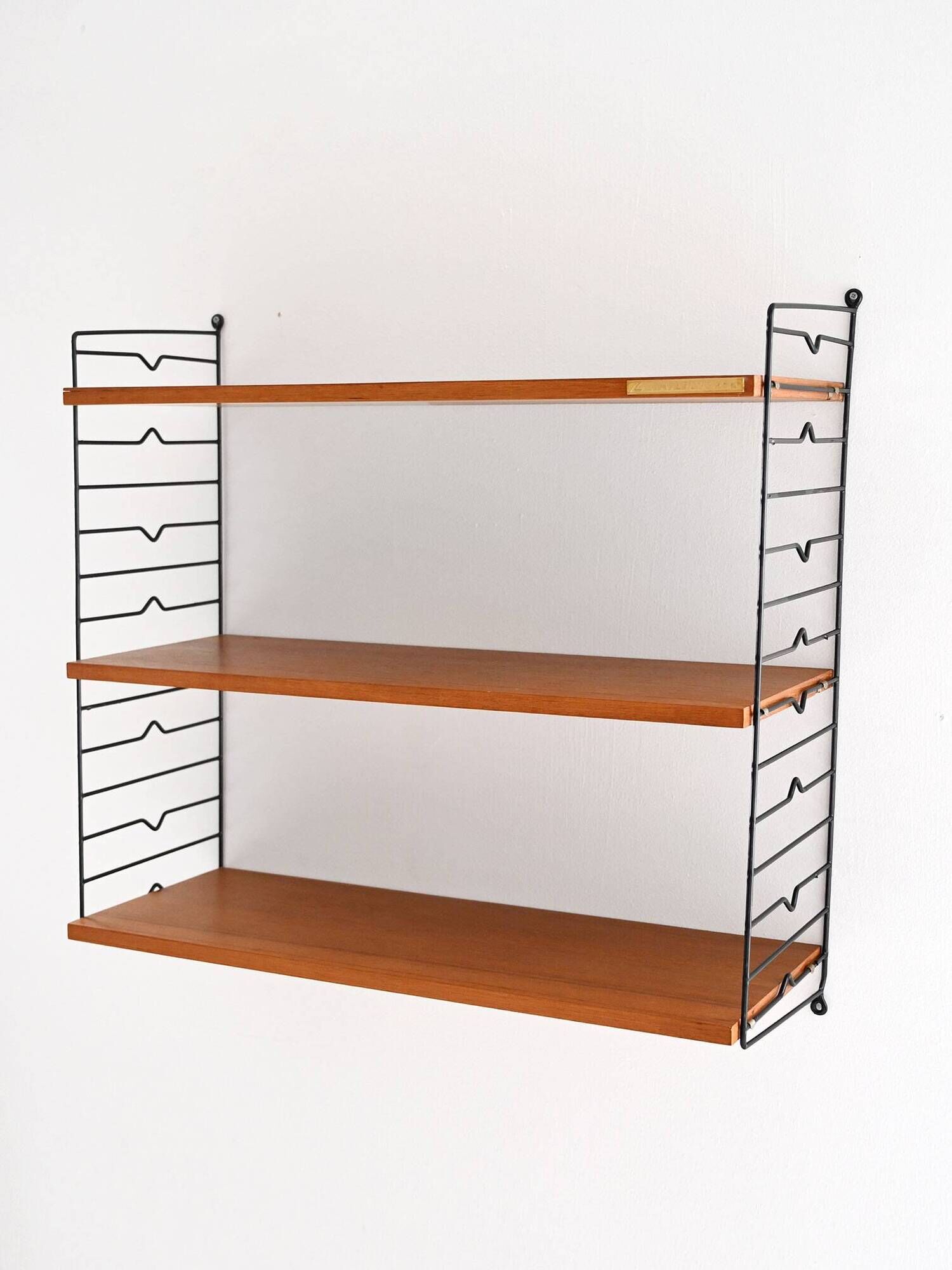 Scandinavian Hylla teak wall shelf with brass label