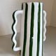 Green and white striped ceramic vase with abstract handmade corrugated handheld