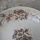Flat serving compote dish in Terre de Fer HB & Cie with brown floral decoration.