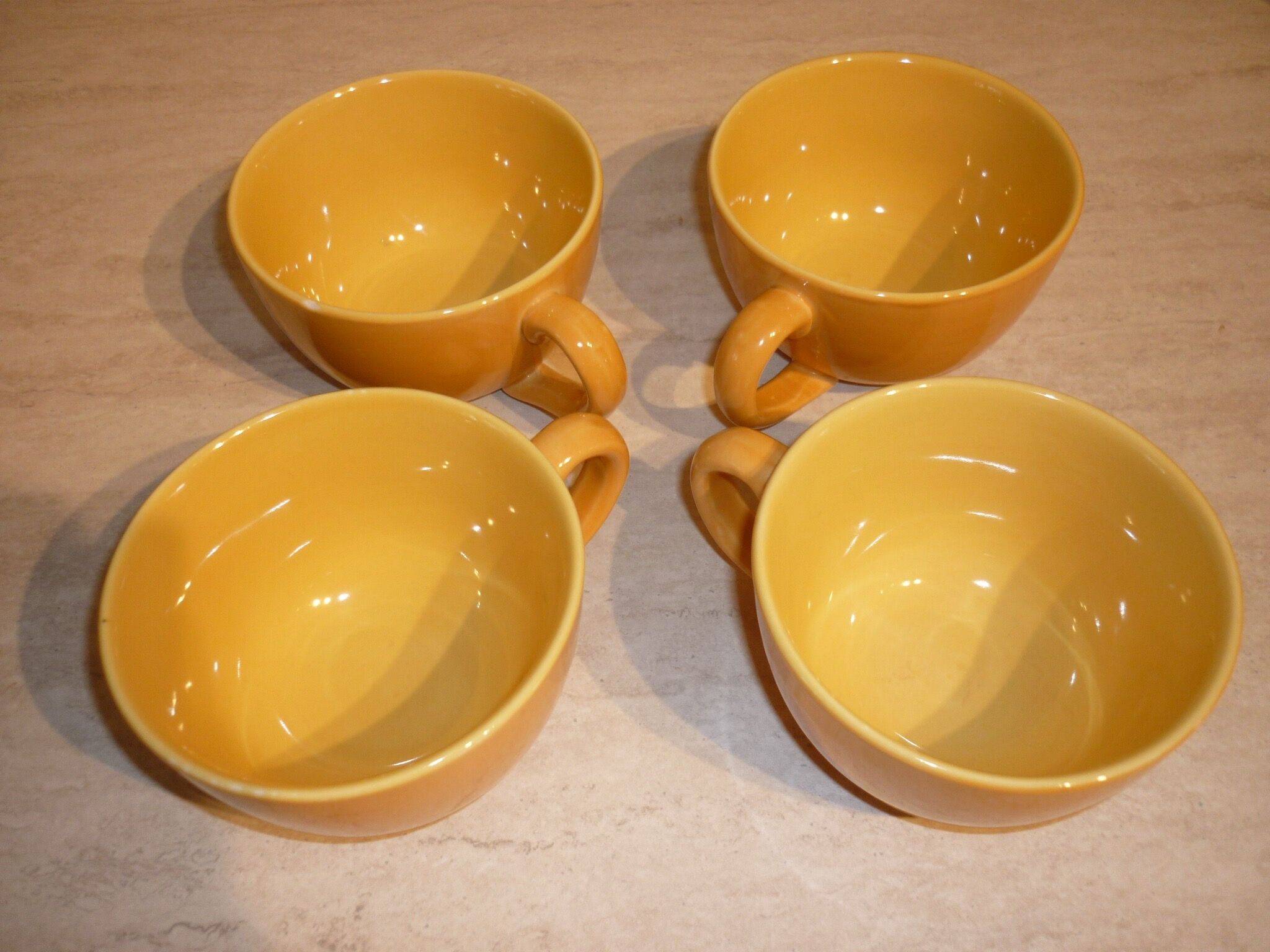 4 yellow and orange ceramic cups