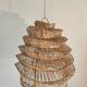 Braided rattan suspension in the shape of a natural accordion