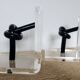 Bookends in plexiglass and knotted black tubes, 1980s design.