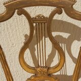 Pair of chairs with a golden lyre