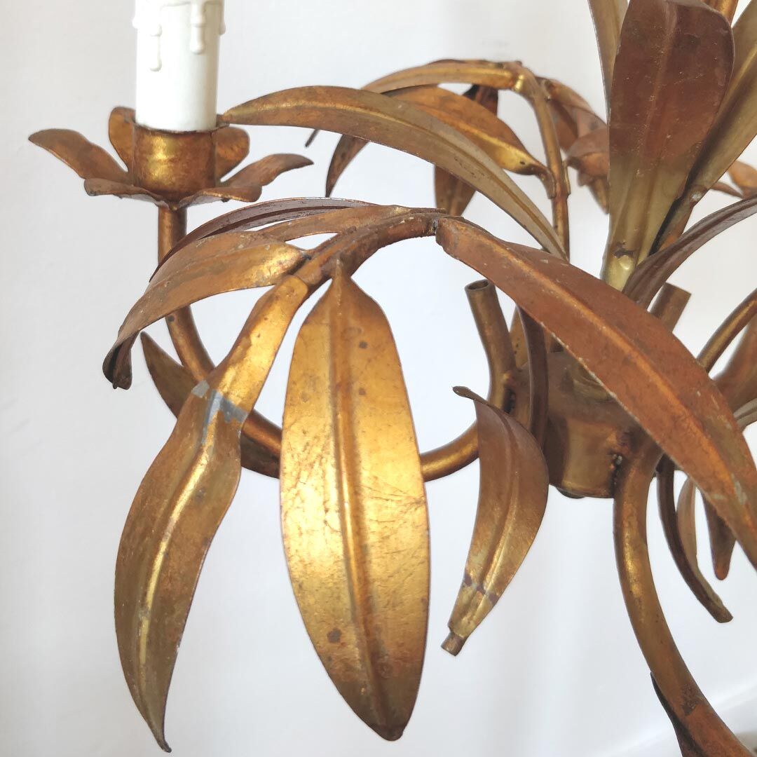Golden metal chandelier palm leaves
