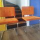 Pair of vintage cantilever chairs in chrome and orange corduroy.