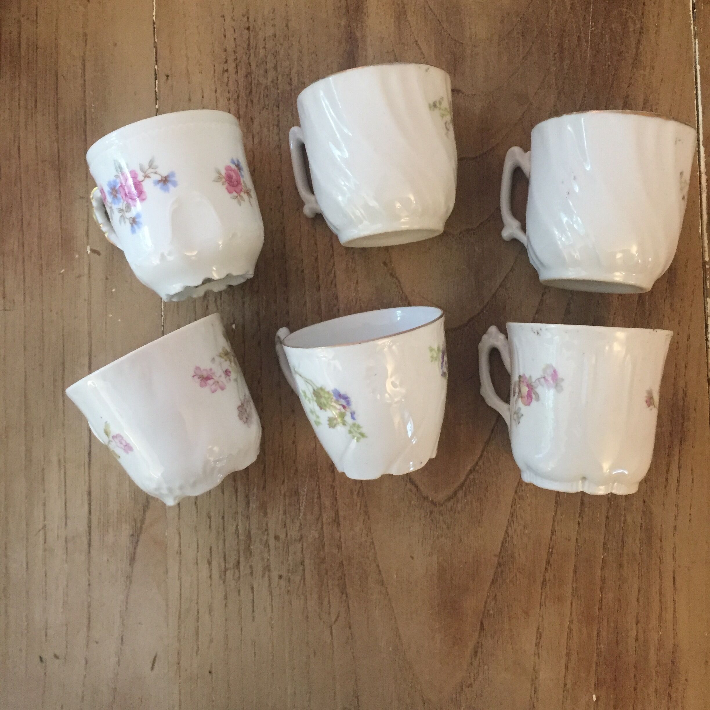 6 antique cups and mismatched saucers