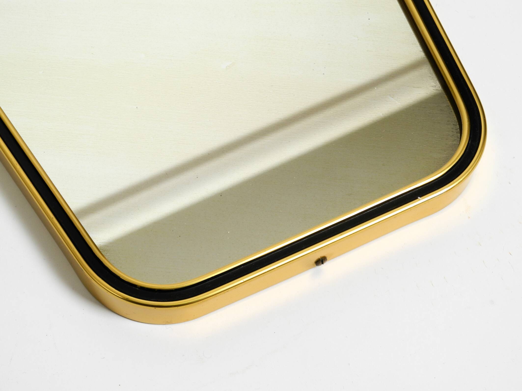 Beautiful small mid-century brass wall mirror with braided hanging strap