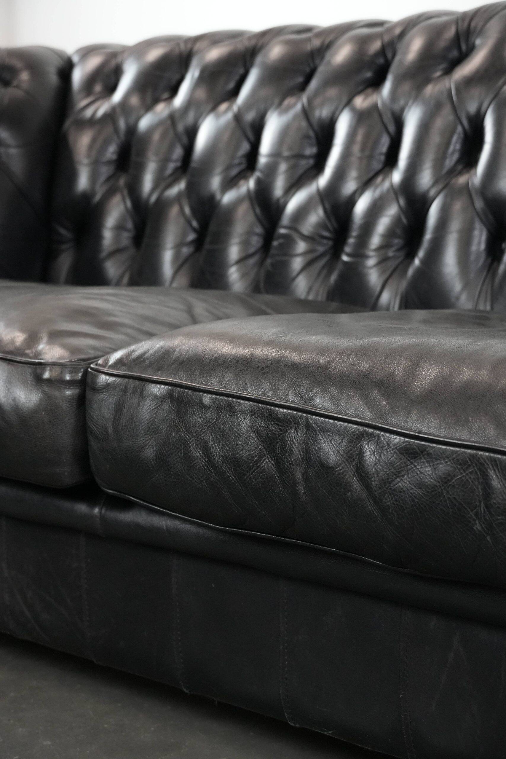 Black chesterfield 3-seater sofa made of cowhide leather in English style