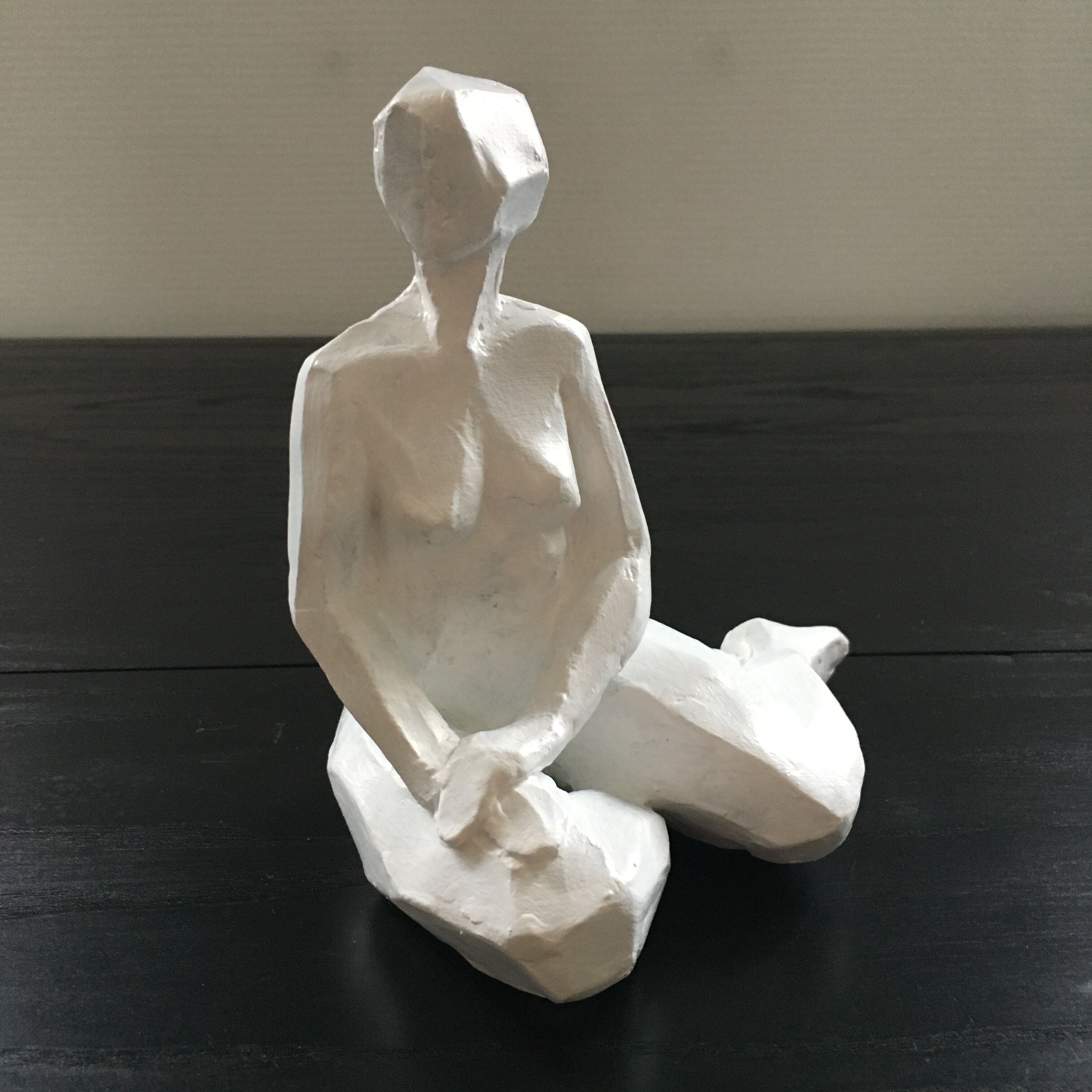 Statuette woman seated in plaster