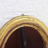 Golden oval mirror