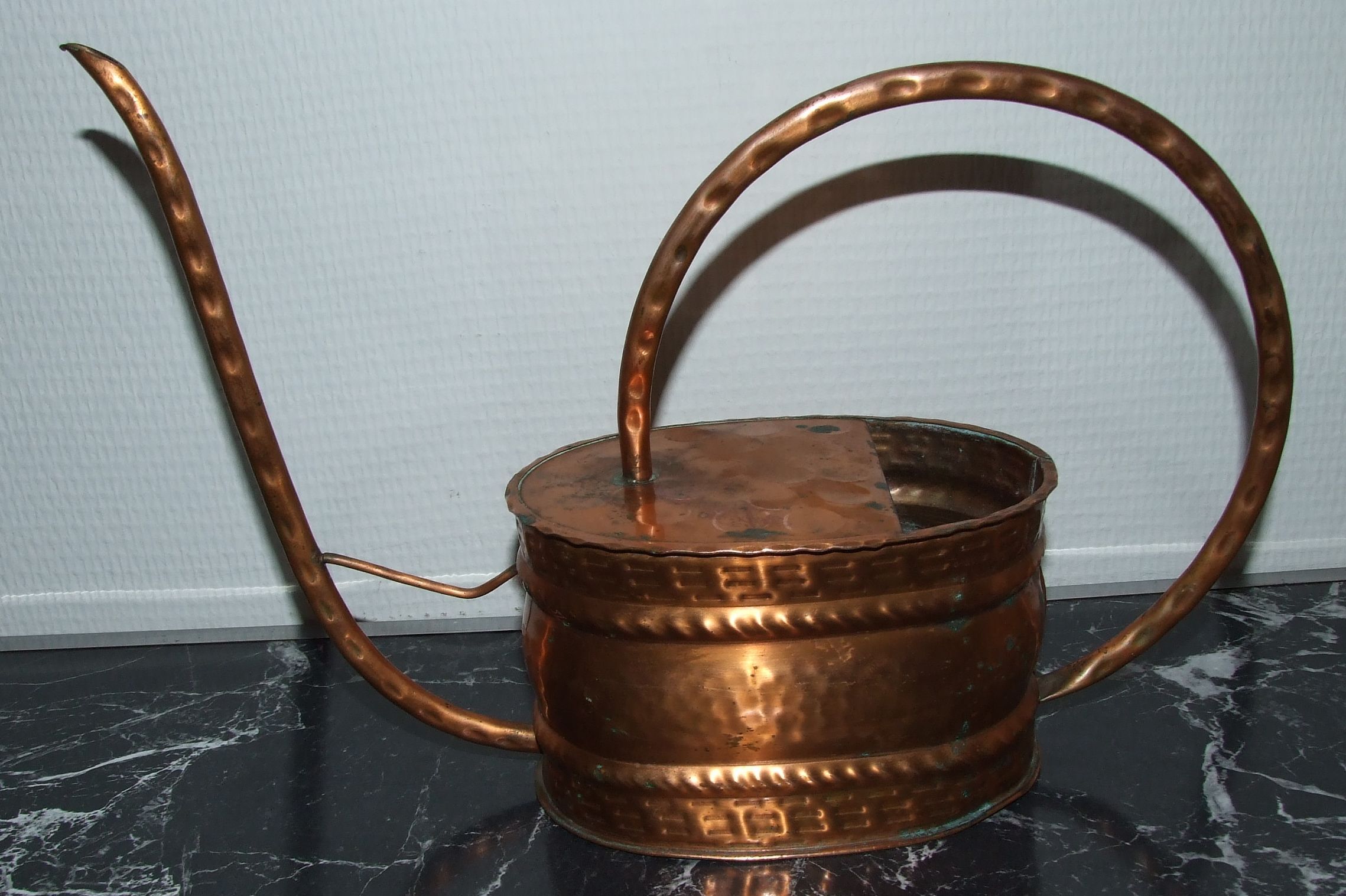 Old copper watering can