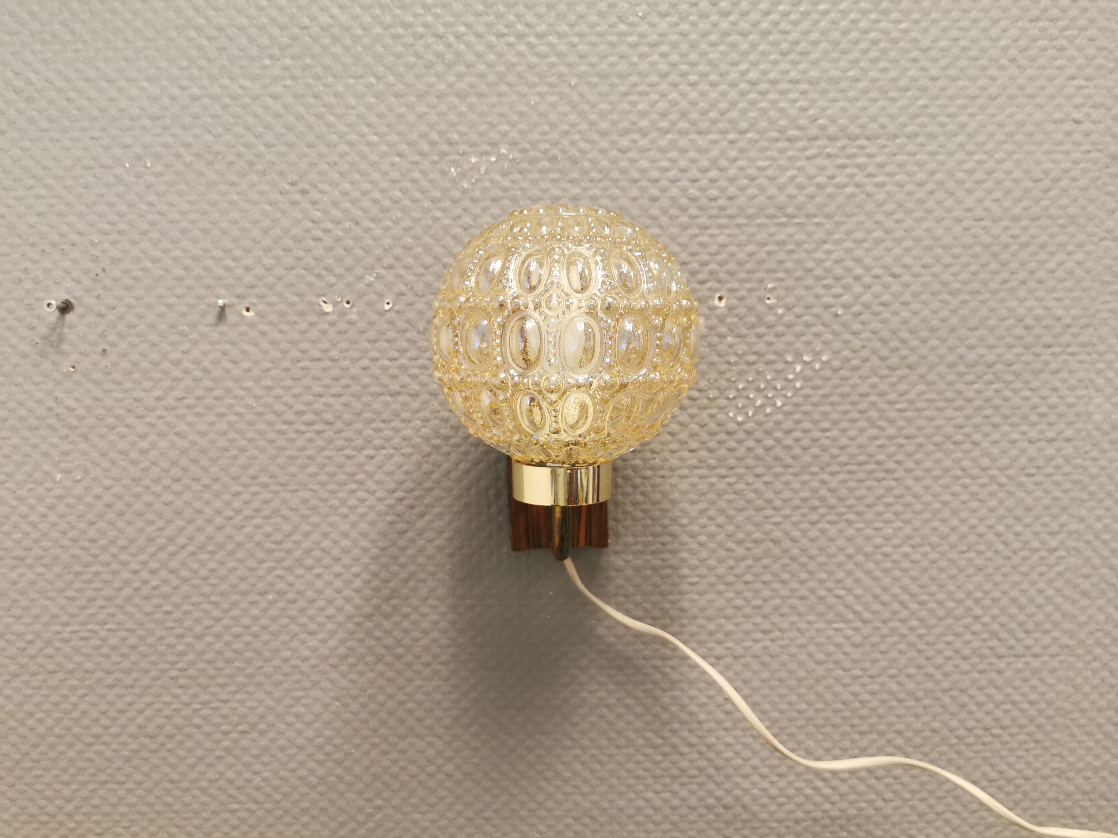 Wall light in rosewood with bobble glass ball shade.