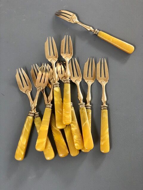 Brass and yellow galathite cake forks