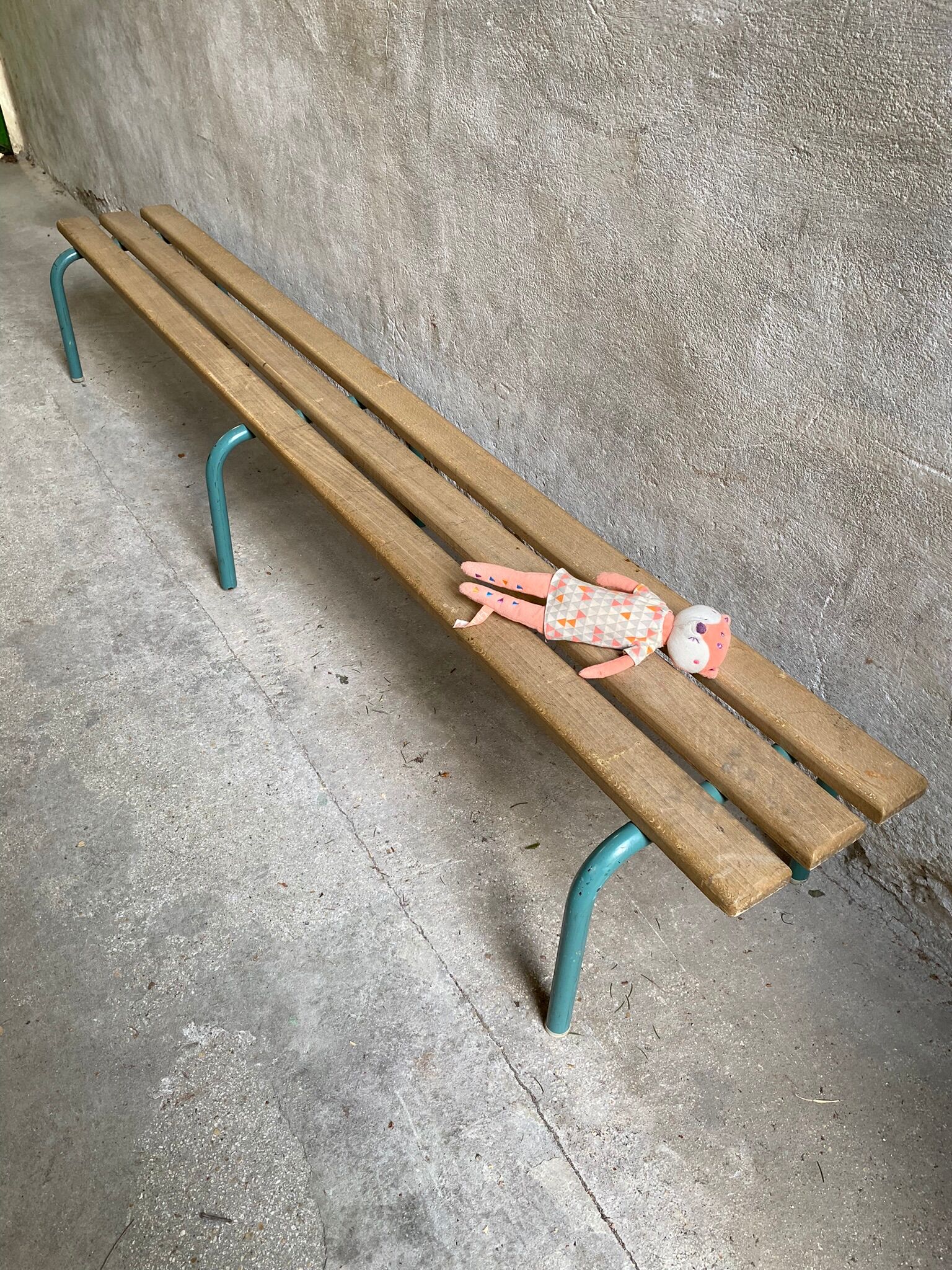 Vintage wood kindergarten bench and tubular structure in long