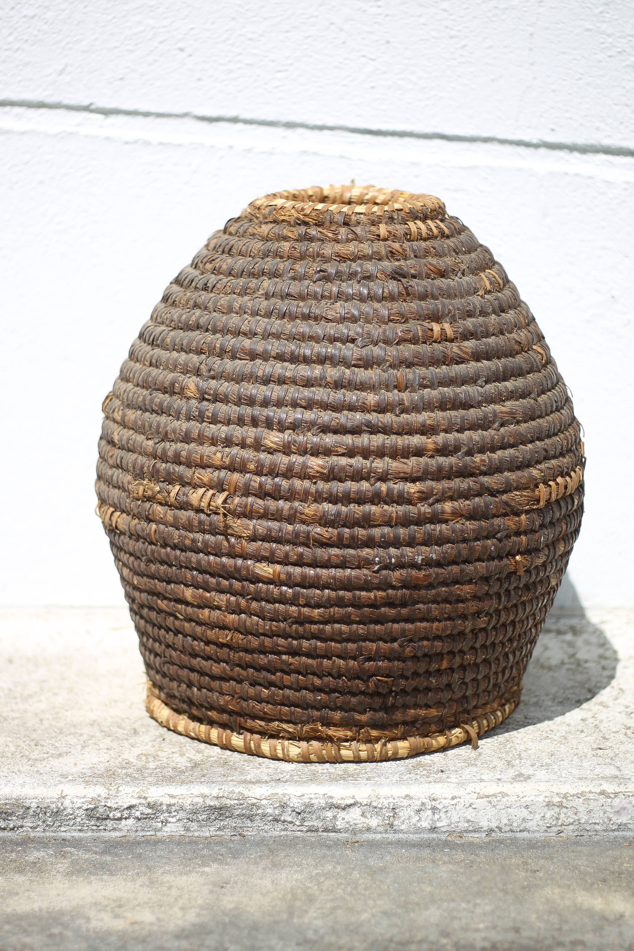 Old basket, burgundy straw and bramble, woven basket, interior decoration, pantry, flowerpot