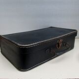 Small suitcase in old navy blue cardboard