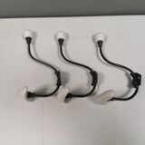 Coat hooks made of galvanized brass and raw white porcelain