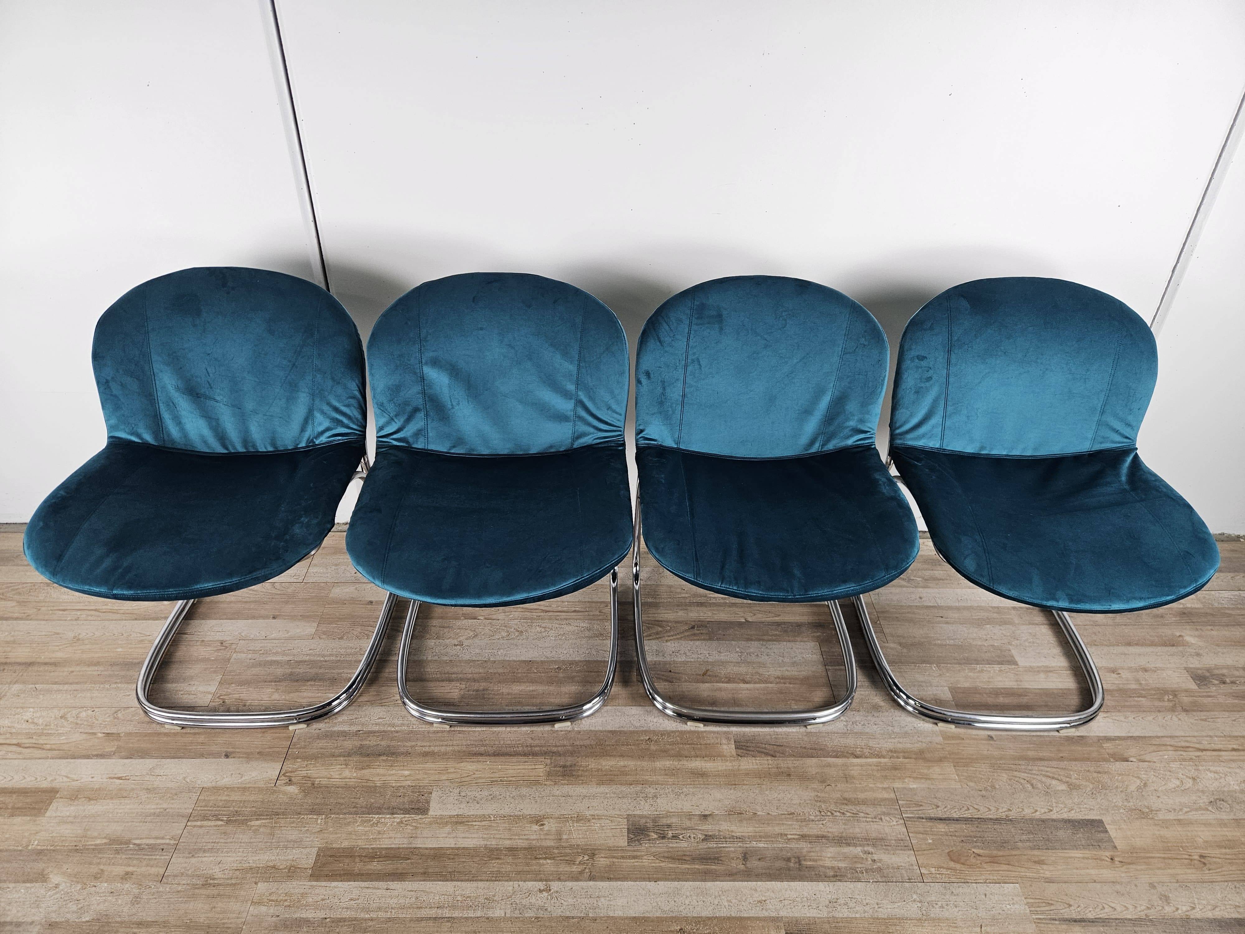 Four 1970s tubular chairs upholstered in blue velvet