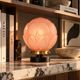 Penelope — Art Deco table lamp in sculpted pink glass, black brass base.
