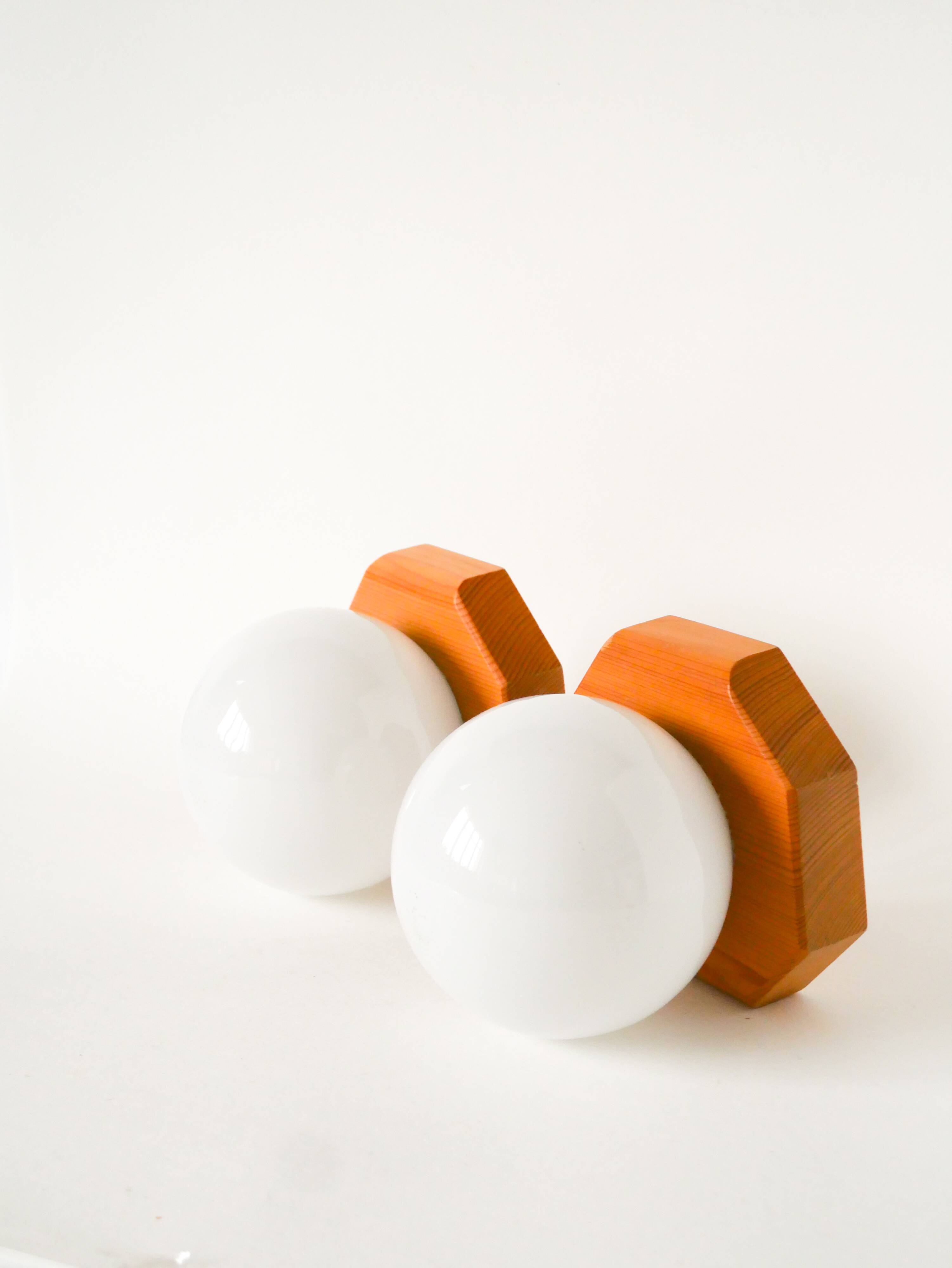 Pair of globe wall lights in opaline with a pine base, 1980.