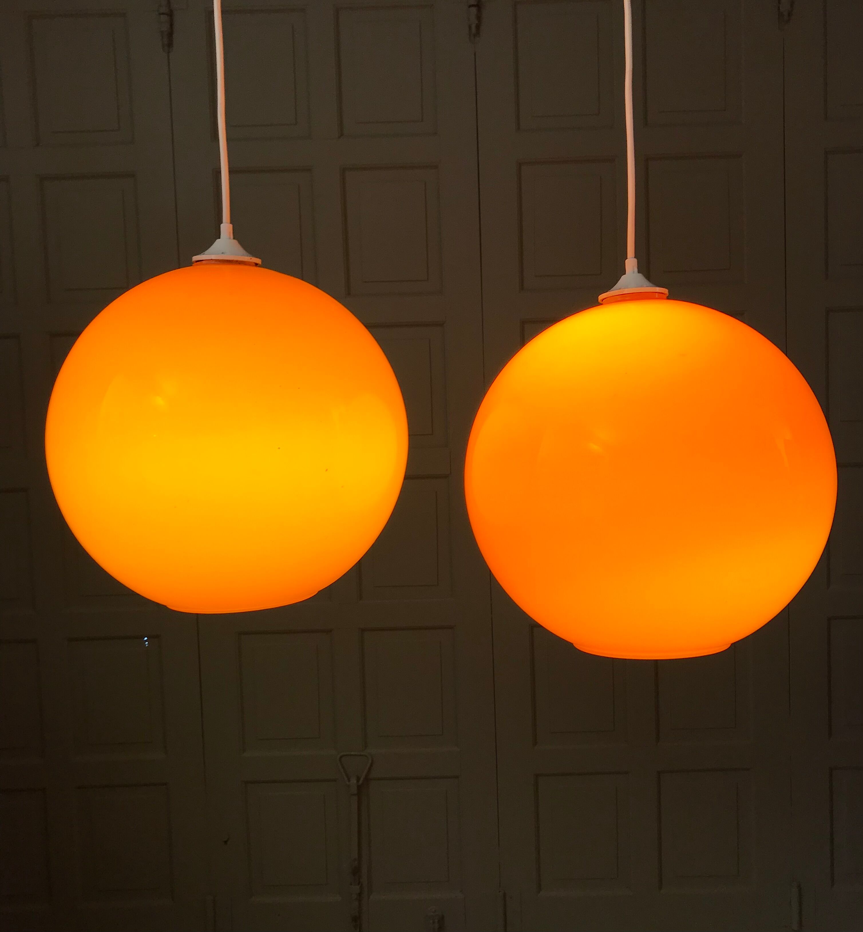 Pair of orange glass ball suspensions, 70s.