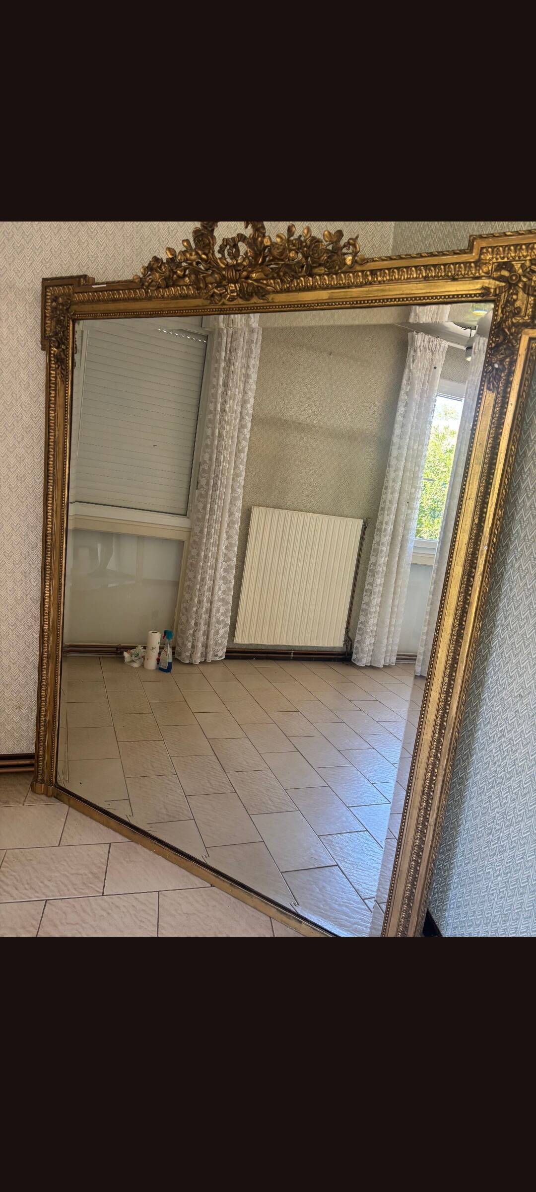Large mirror from the Napoleonic III era with a floral pediment.