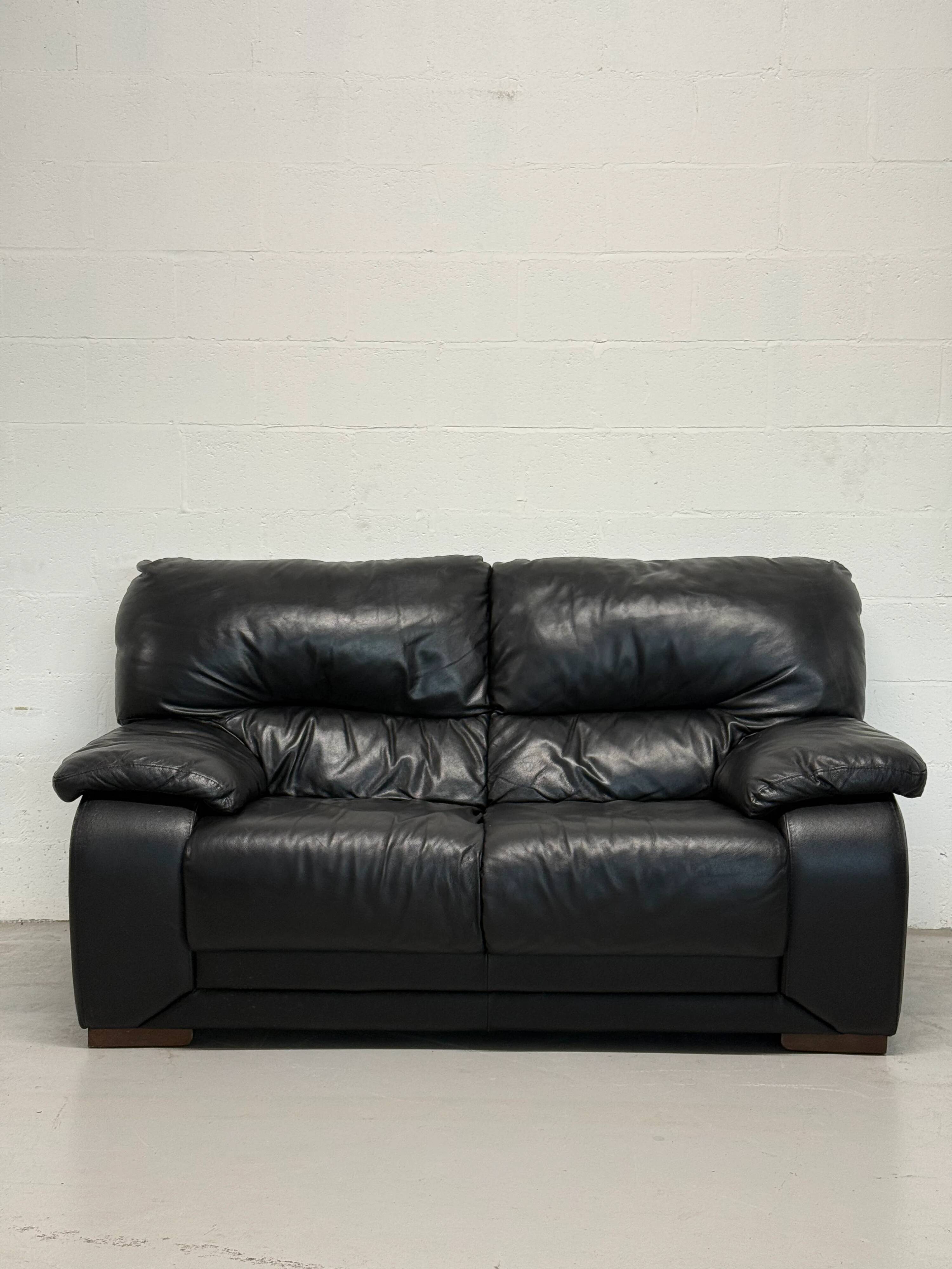 Two-seater black leather sofa — Italian postmodern design