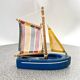 Wooden bathtub sailboat, perhaps a Tirot.