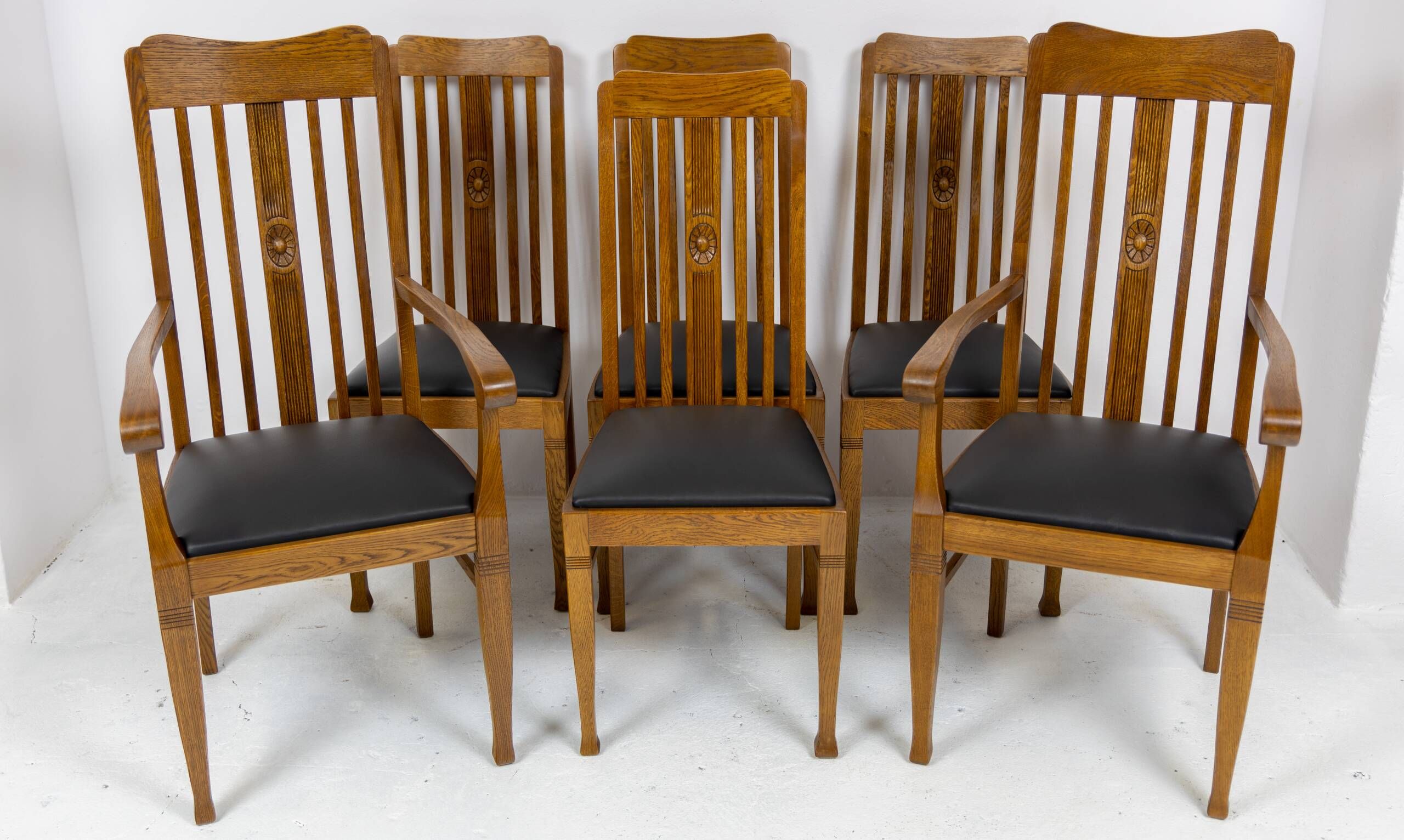 Set of 6 Art Nouveau chairs and armchairs in oak and leather.