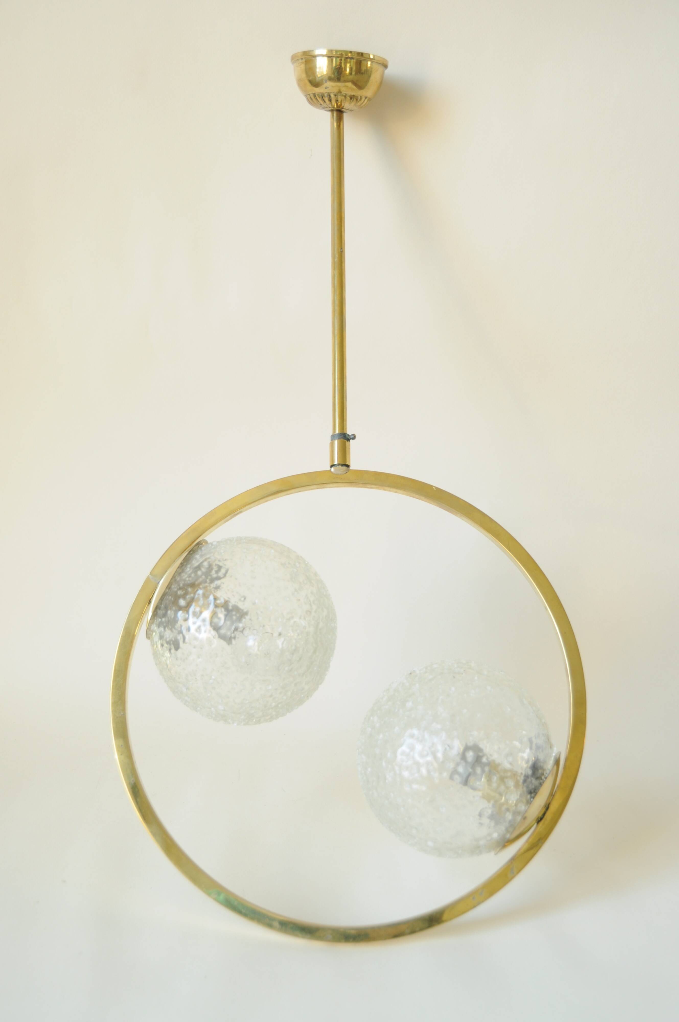 Mid century modernist pendant light in brass and textured glass ball
