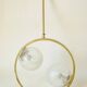 Mid century modernist pendant light in brass and textured glass ball