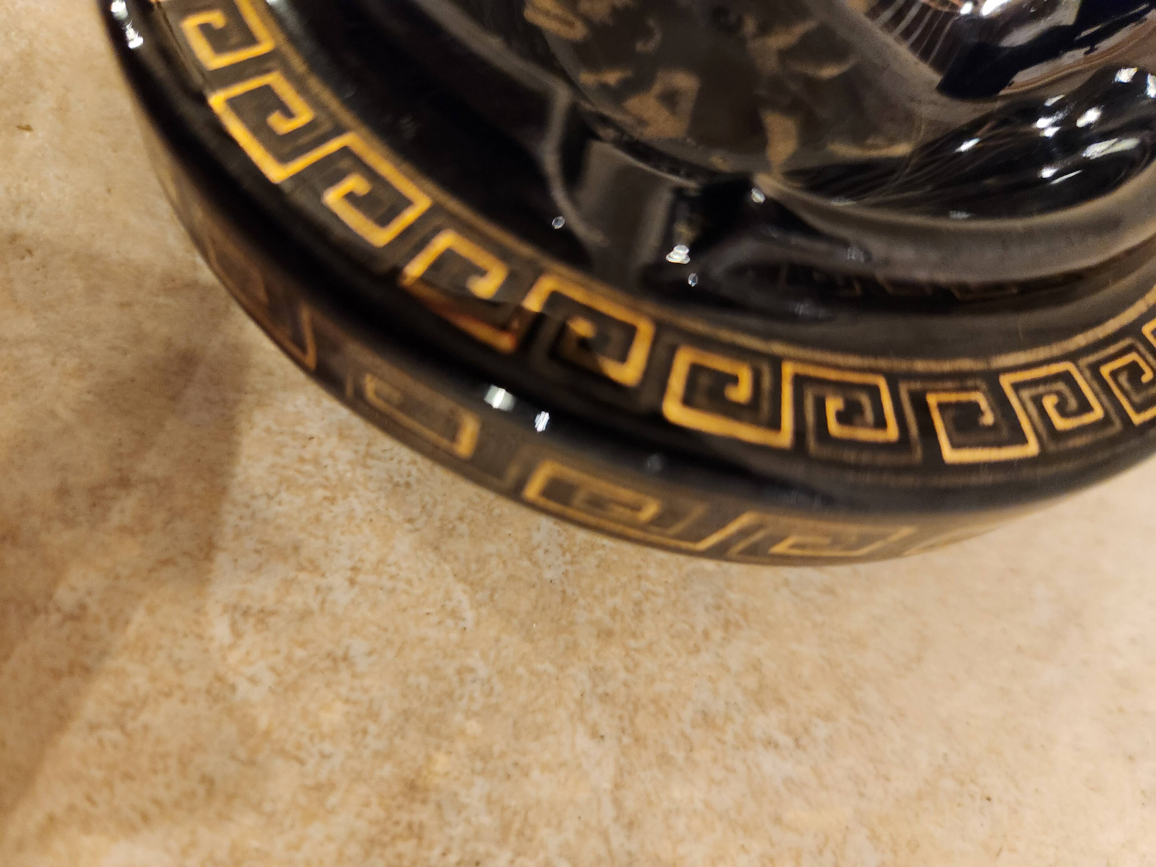 Small vintage ashtray in black ceramic with gold decoration in Greek style.