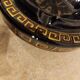 Small vintage ashtray in black ceramic with gold decoration in Greek style.